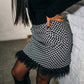 beautiful black haired lady in a black top nad black and white feather skirt - this is a two piece dress, that can be split into top and skirt