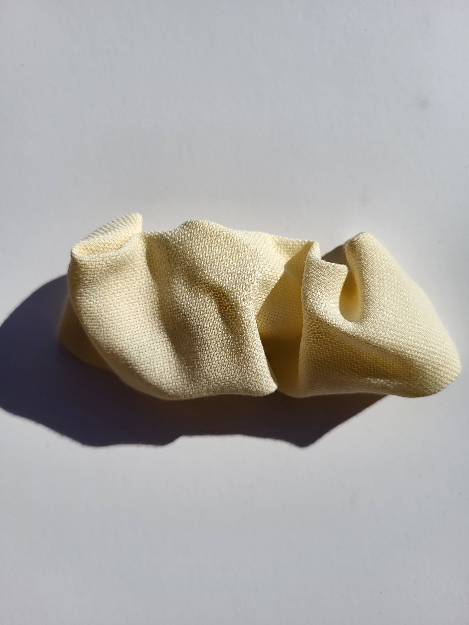 yellow hair clip on white table