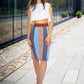 beautiful woman in white three piece dress and white shoes. standing in the sun, striped shirt. brunette