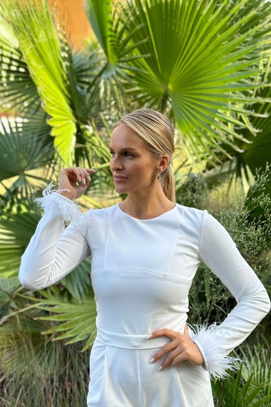 beautiful blond woman in white jumpsuit in palm trees