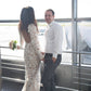 a couple on thei wedding day - casual husband and lace wedding dress from the back