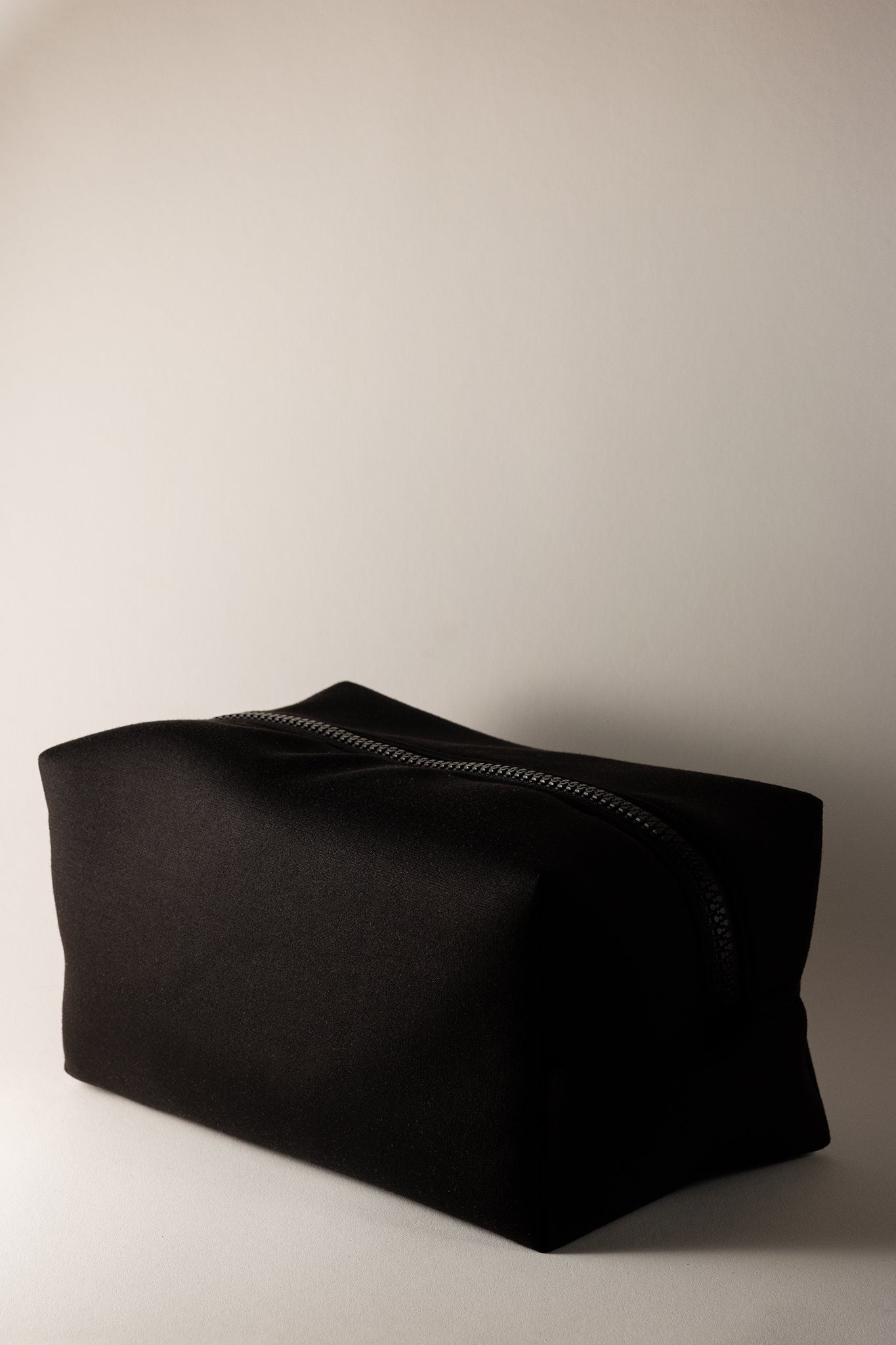 black boxy cosmetic bag