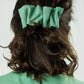 mint green hair clip pinned in the hair