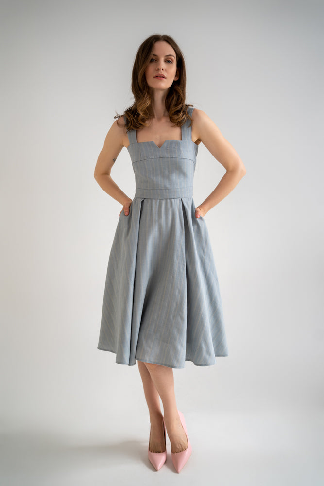 beautiful woman in a light blue two-piece dress set - a corset top and a flowy a-lined skirt with pockets