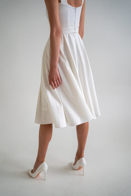 Clear white skirt has an A-lined shape and pockets. This skirt is a separate part of the transformable dress set so later on you can add any top of your choice and connect the both parts with snaps. This skirt is perfect for everyday occasions as well as office wear and more special events depending on accessories you choose to pair this piece of clothing with. White jersery skirt. Flowy skirt.